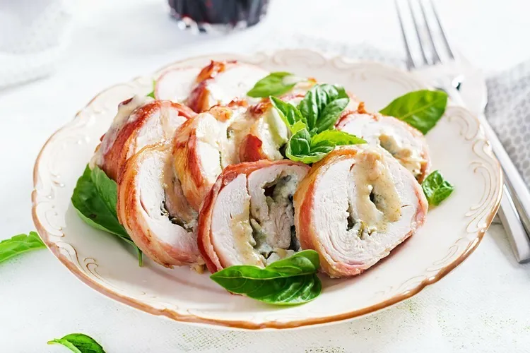 Apple-stuffed baked chicken breasts with white wine sauce