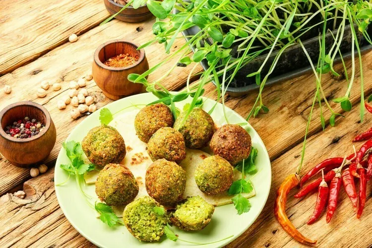 Baked herb & pistachio falafel with tomatoes, spinach and jalapeno