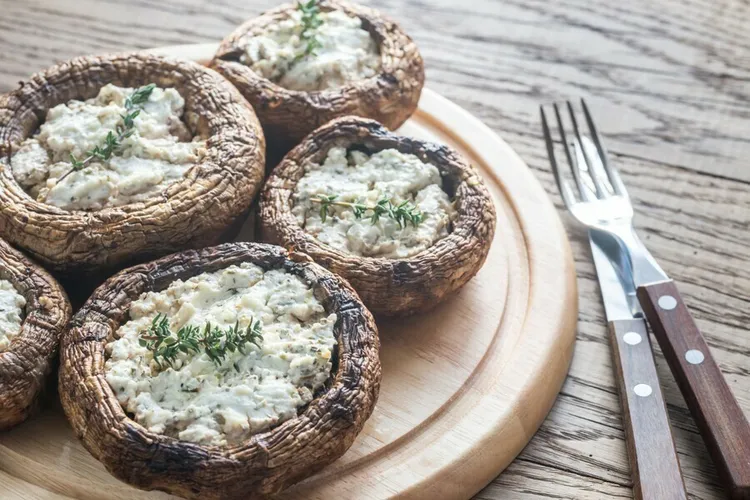 Baked portobello caps with melted goat cheese and pine nuts