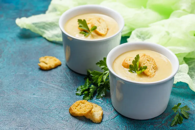 Baked potato and cauliflower soup with chives and cheddar cheese