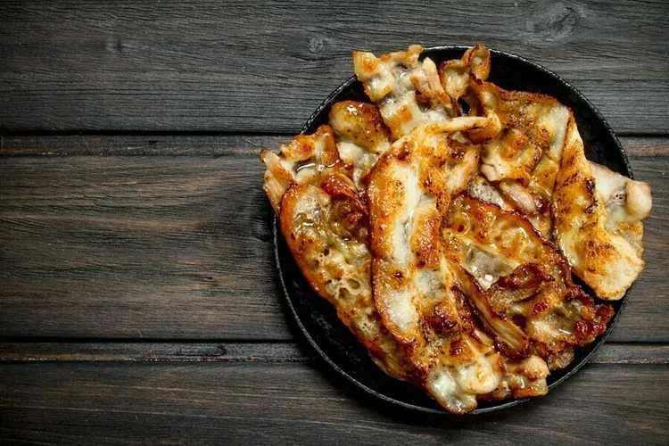 Bbq chicken pita pizza with red onion, pepper and monterey cheese