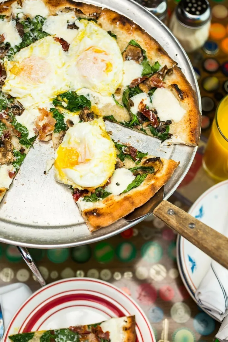 Egg and spinach pita pizza with mozzarella, parmesan and spices