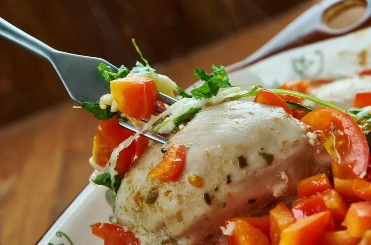 Grilled caprese chicken with cherry tomatoes and mozzarella cheese