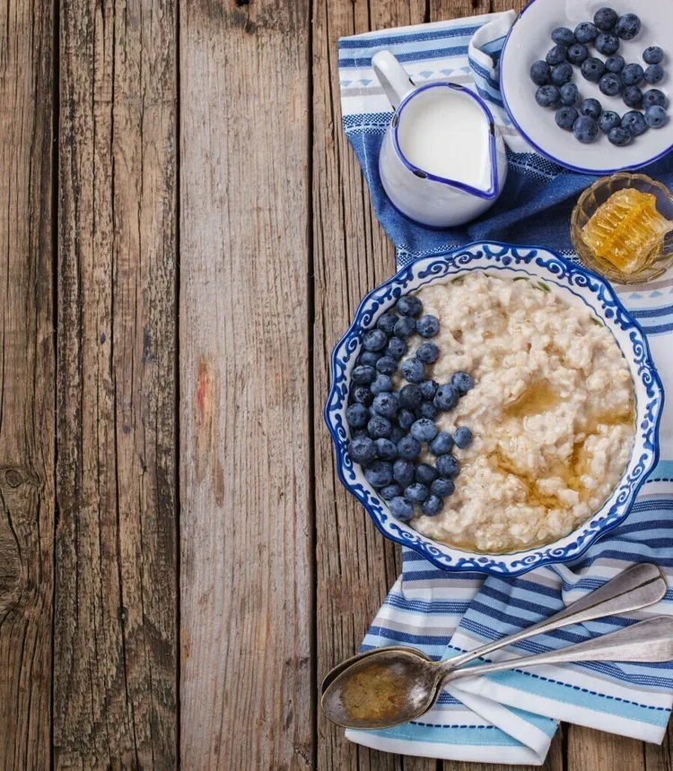 Cinnamon porridge bowl with blueberries and greek yogurt