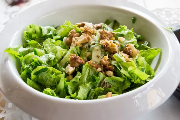 Crisp lettuce, cucumber and walnut salad with olive oil and spices