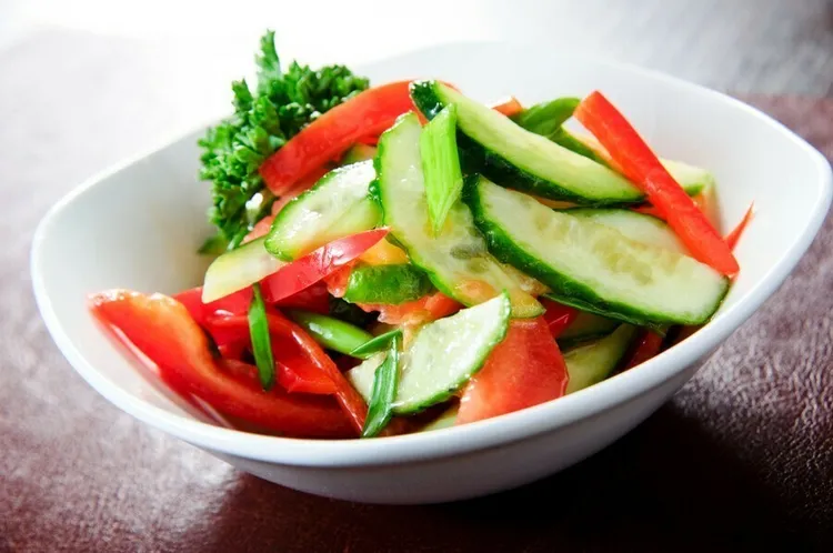 Deli cucumber salad with onions, red peppers and vinegar.