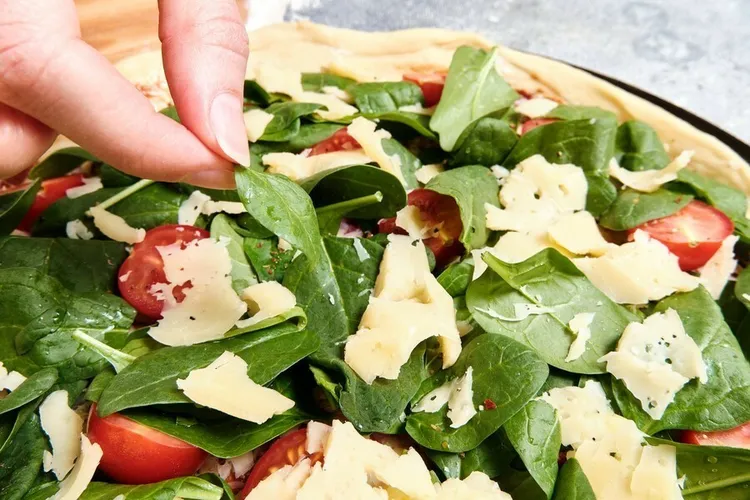 Tofu spinach pita pizza with tomato, parmesan and mozzarella