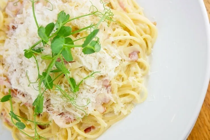 Gluten-free bacon carbonara with whole-wheat spaghetti and parmesan cheese