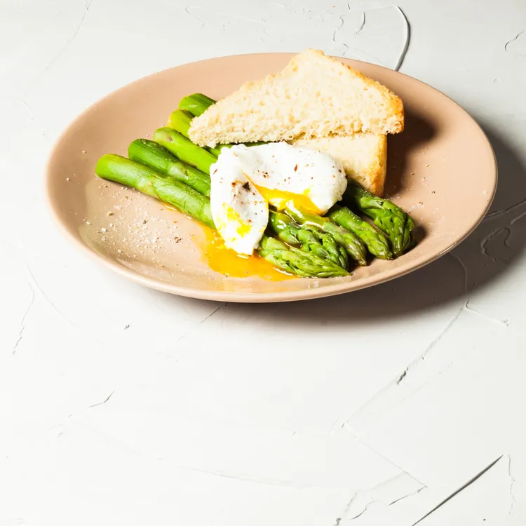 Grilled asparagus and poached egg toast with parmesan and spearmint