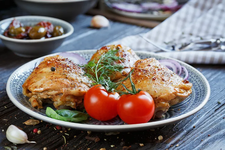 Grilled chicken thighs with onion, salt, olive oil, sugar and black pepper