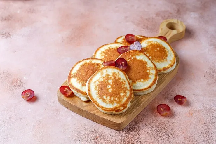 Multi-grain oatmeal pancakes with cottage cheese and maple syrup