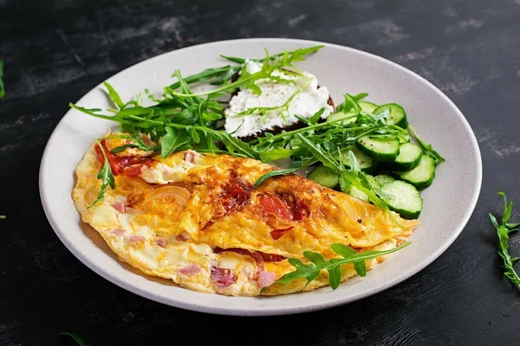 Bacon and goat cheese omelette with onion and dill