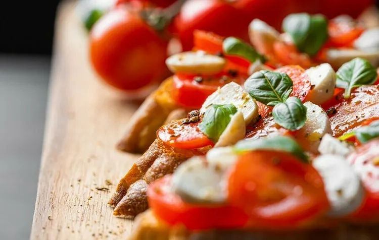 Baguette mozzarella sandwich with tomato, basil and olive oil vinaigrette