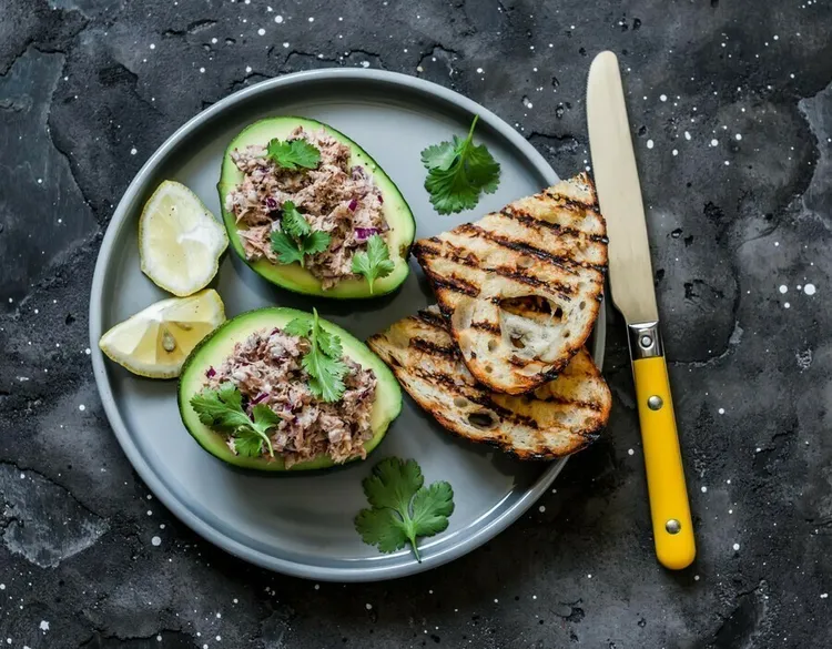 Paleo avocado tuna salad with lemon, onion and spices