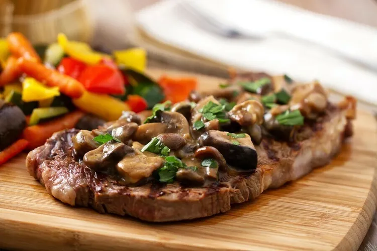 Pan-seared peppered steaks with mushroom and spinach sauce
