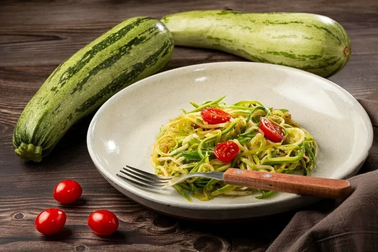 Garlic-infused zucchini noodles with cherry tomatoes and spices