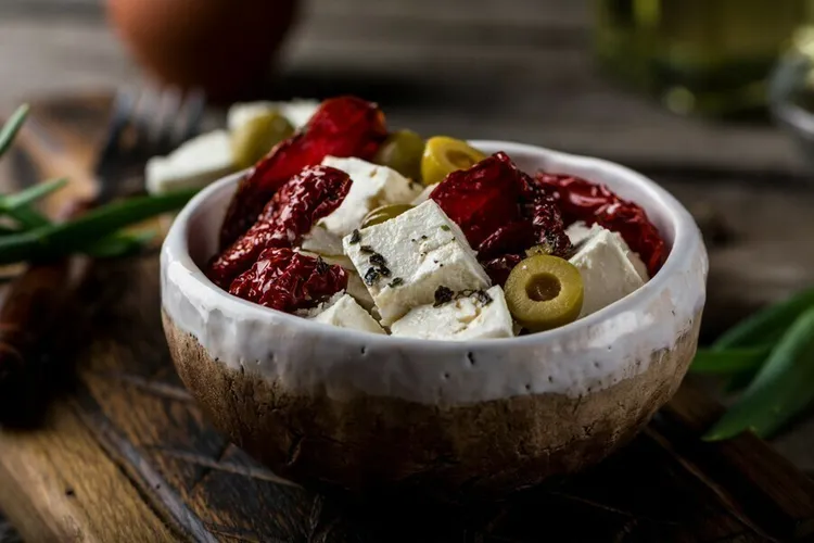 Roasted feta with olives, red peppers and pita bread