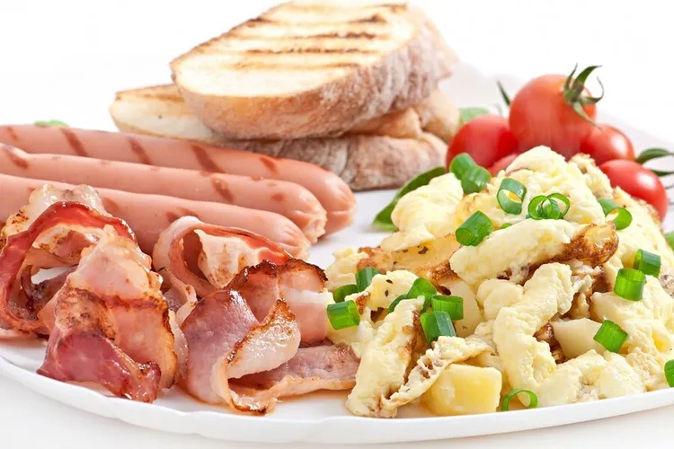 Breakfast scramble on toast with bacon and sausage