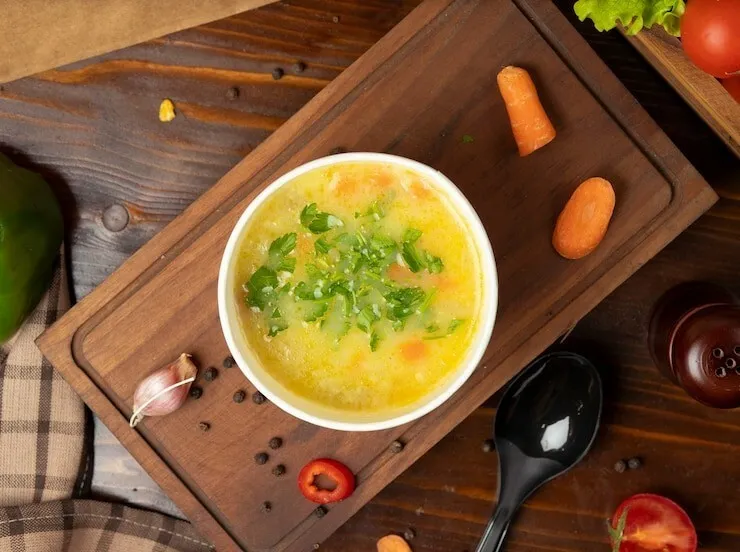 Chicken soup with avocado, carrot and potato