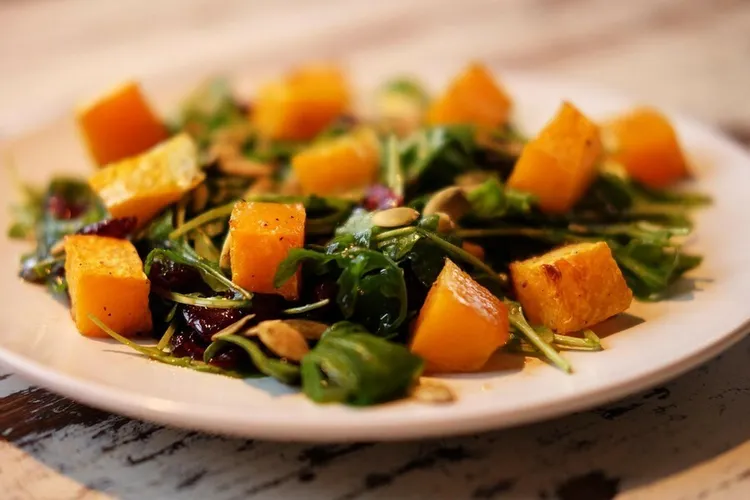 Roasted squash and spinach salad with almond dressing
