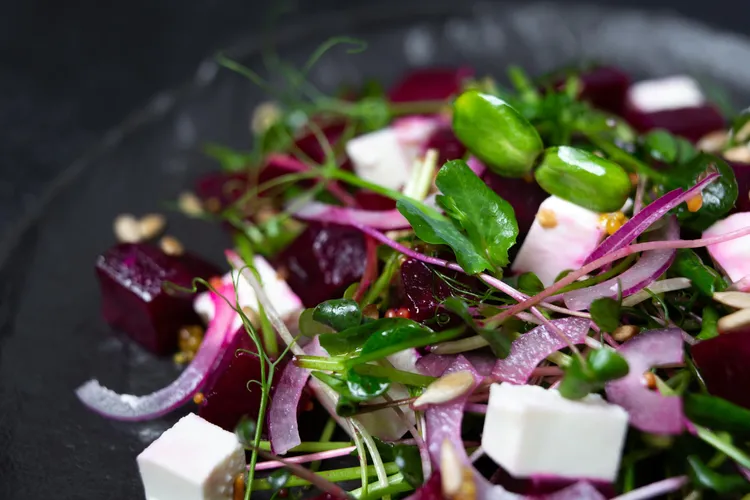 Fresh summer herb beet salad with arugula, celery and pickles