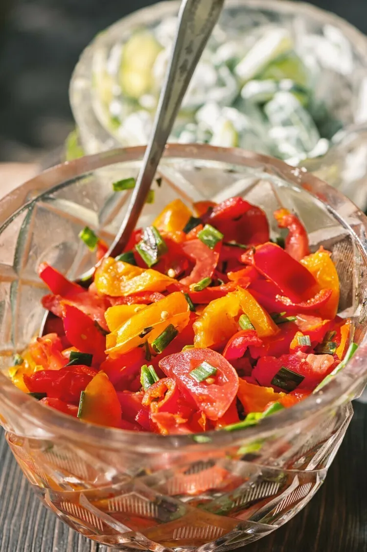 Fresh summer tomato and pepper salad with olive oil and vinegar