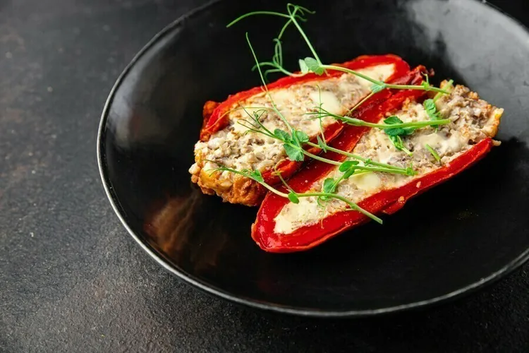 Tuna-stuffed baked peppers with cheddar cheese