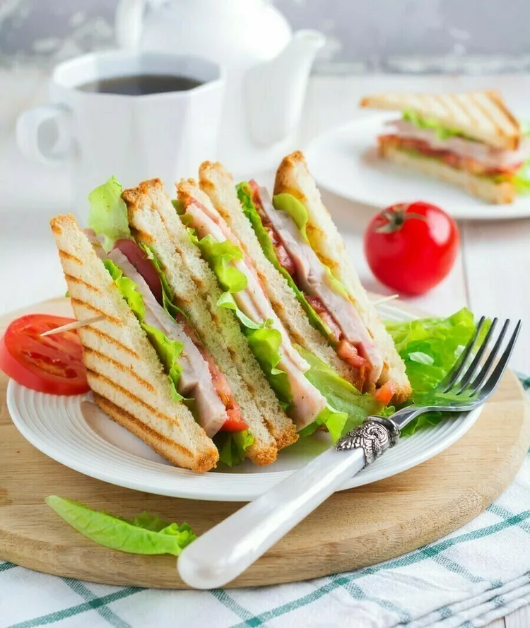Open-faced turkey and swiss sandwich with lettuce and tomato