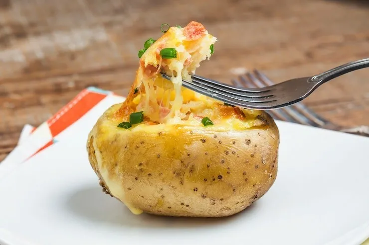 Loaded twice baked potatoes with bacon, cheddar and chives