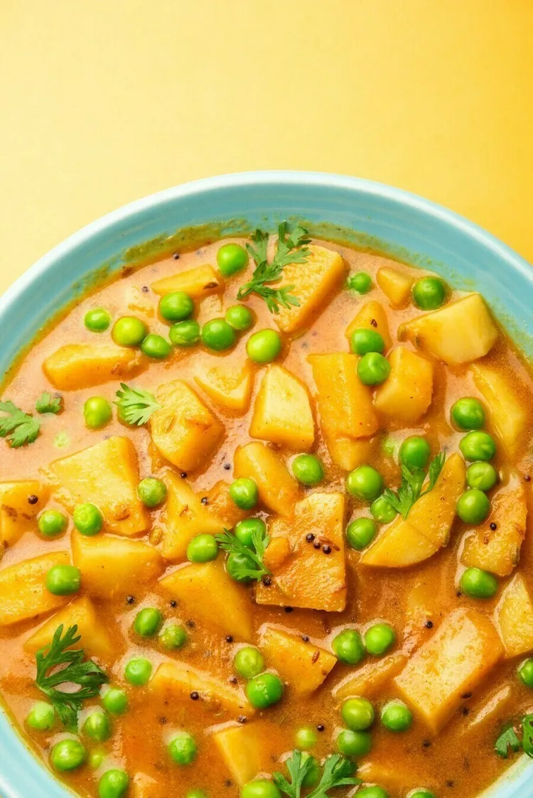 Vegan potato curry with chickpeas, peas and cashews