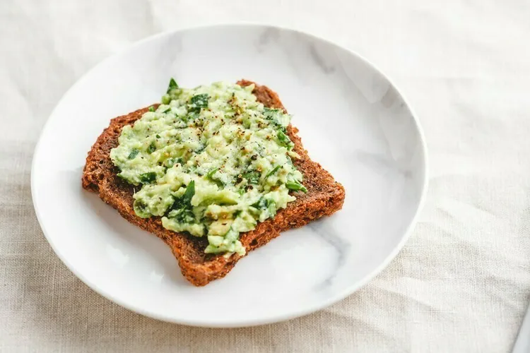 White bean & artichoke toast with basil, lemon and spinach