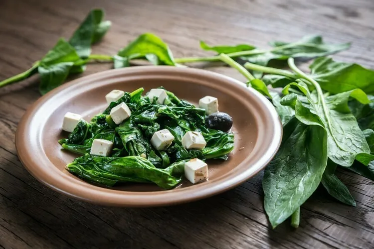 Wilted spinach salad with feta and onion dressing