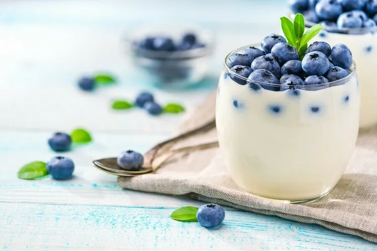 Yogurt bowl with blueberries, sunflower seeds and honey