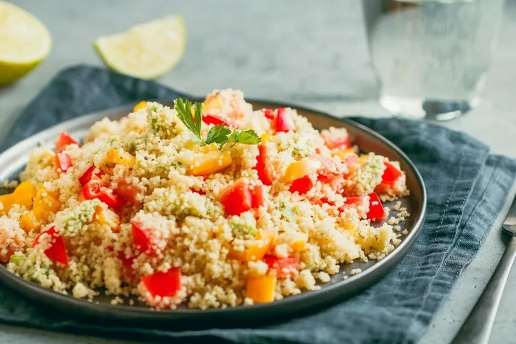 Lemon couscous salad with tomatoes, cucumber and pine nuts