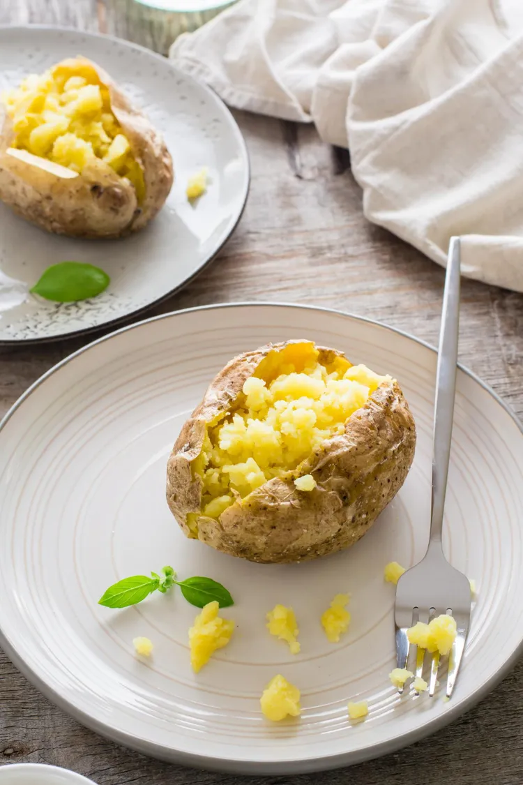 Baked potato with hummus and butter