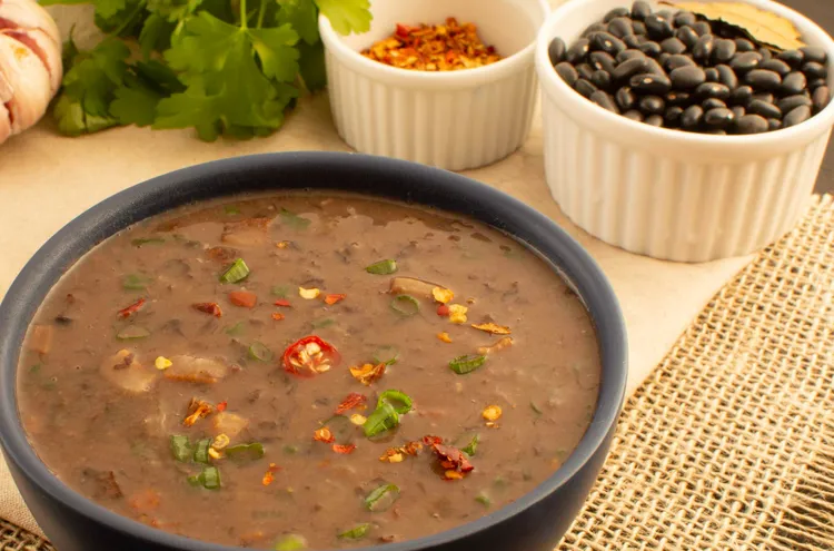 Vegan black bean soup with carrots, celery and sweet corn