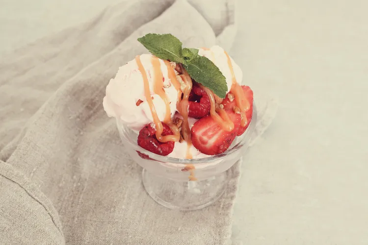 Strawberries with orange syrup and ice-cream