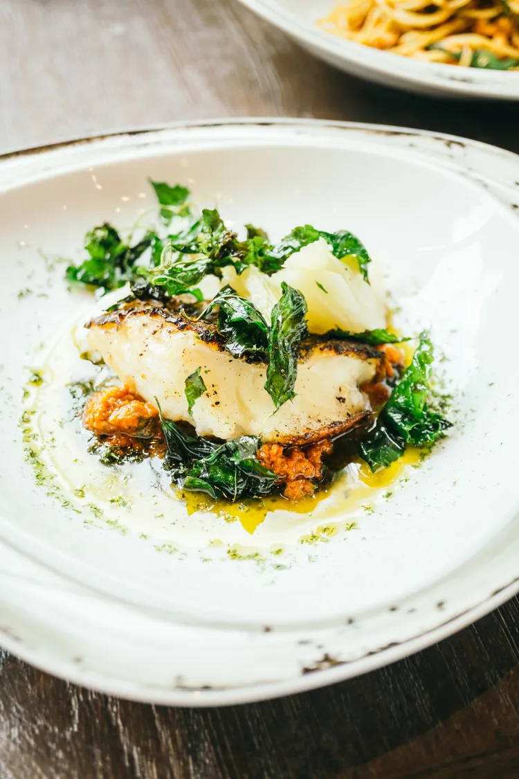 Fish with creamed spinach and tomatoes