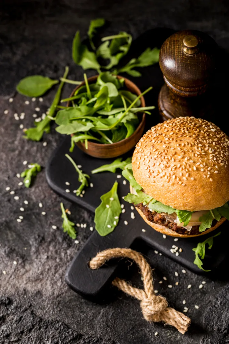 Black bean-quinoa burgers with spicy mayo, avocado and mango