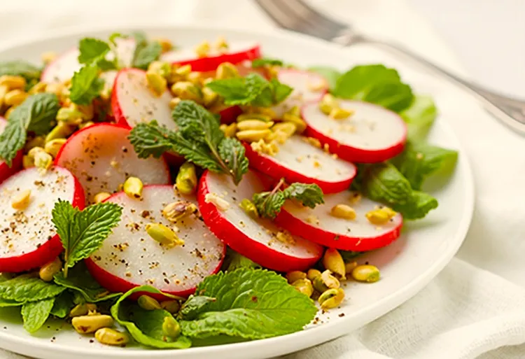 Fresh radish salad with mint, pistachios and lemon