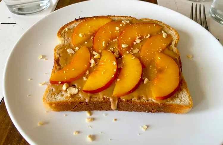 Cinnamon-spiced peaches and almond butter toast