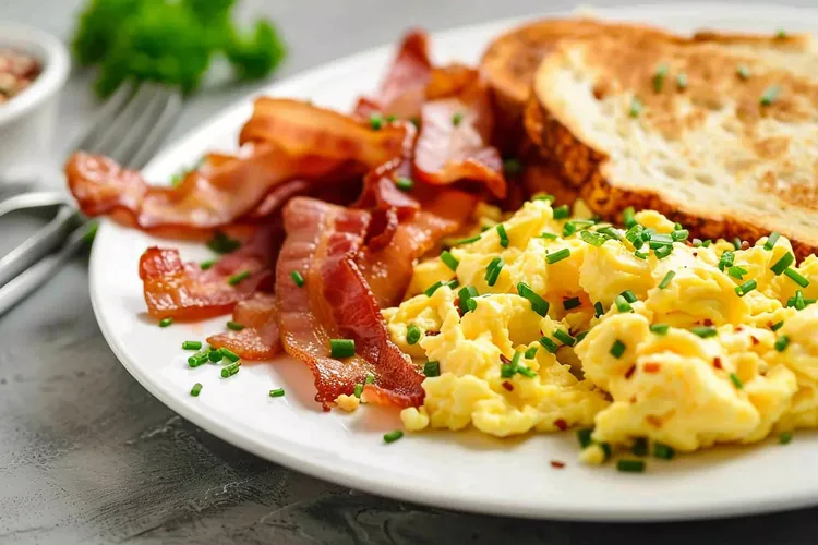 Breakfast scramble on toast with bacon and sausage