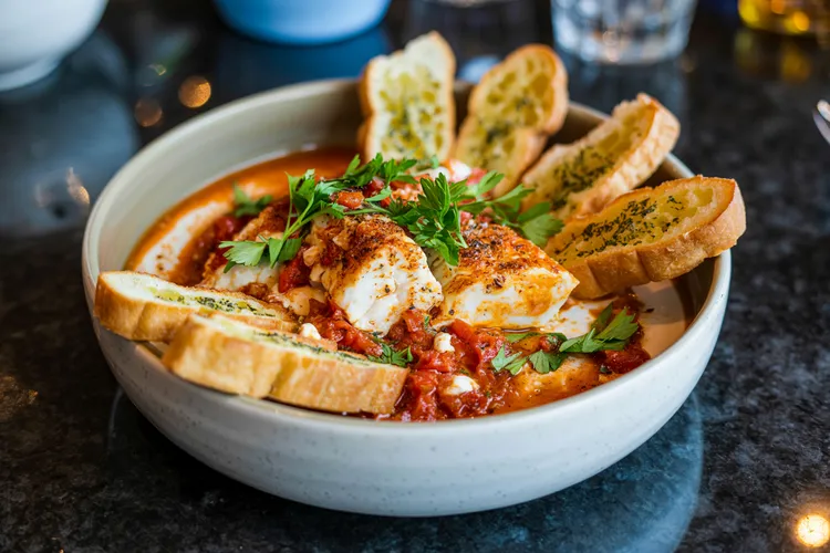 Fish saganaki with garlic toasts
