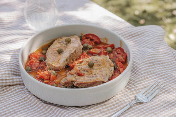 Pork chops with stewed tomatoes and capers
