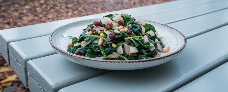 Spinach with currants & pine nuts