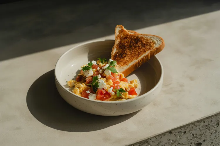 Goat cheese and tomato scramble with multi-grain toast
