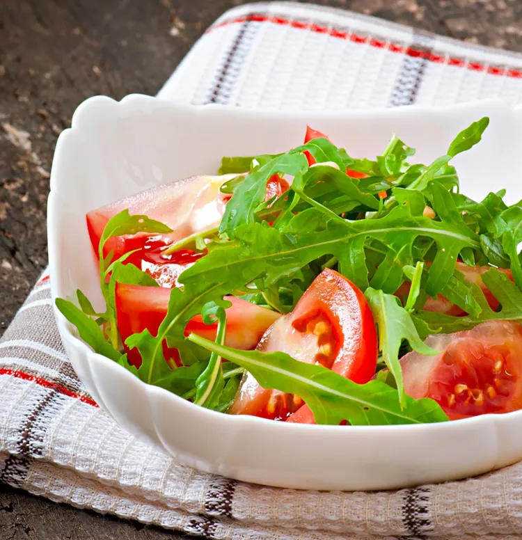 Fresh arugula salad with tomato