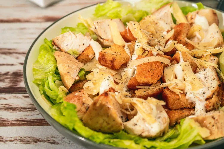 Grilled chicken caesar salad with parmesan cheese